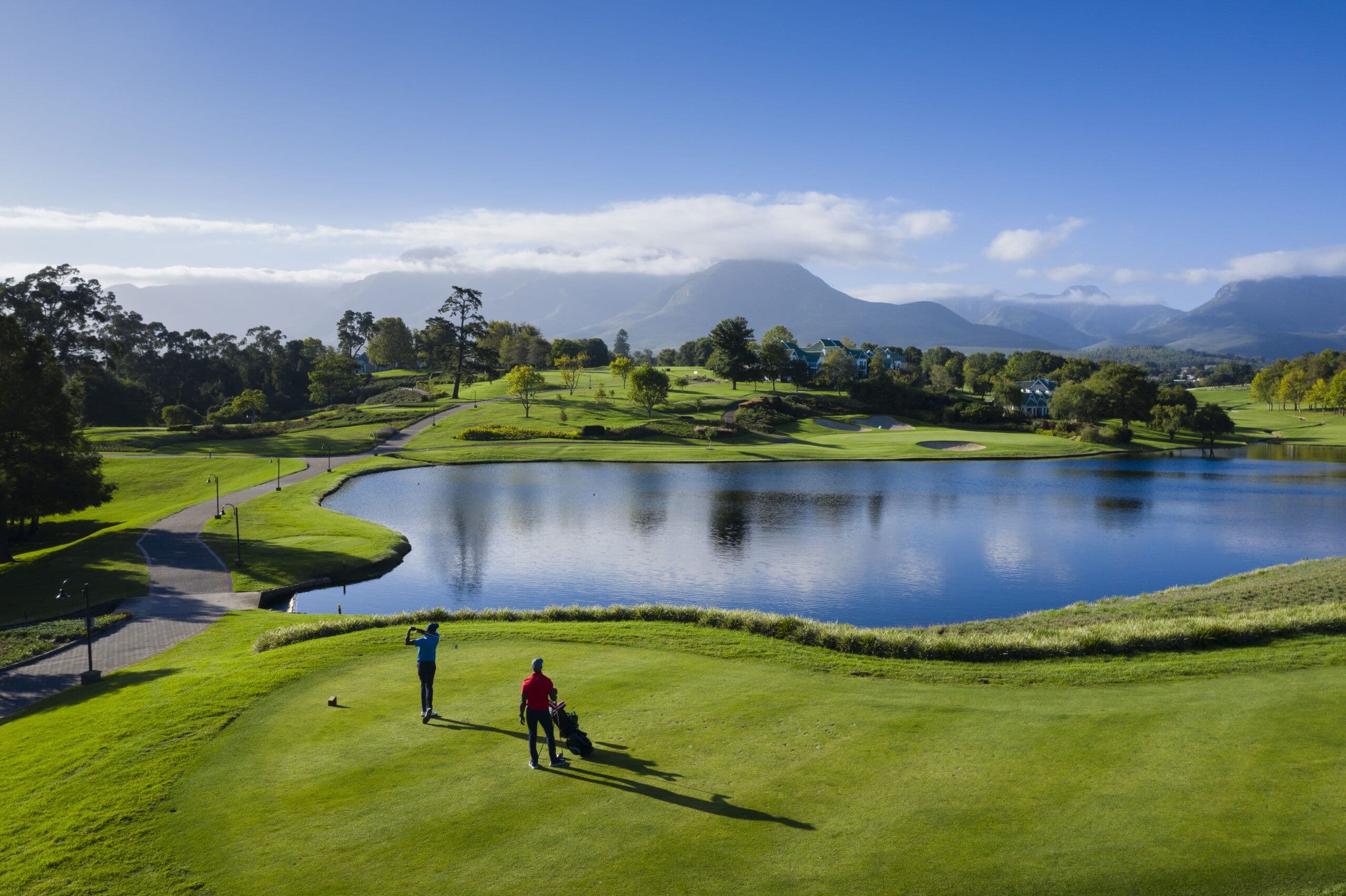 Fancourt resort grounds beneath the Outeniqua Mountains — golf, lake and Garden Route horizon